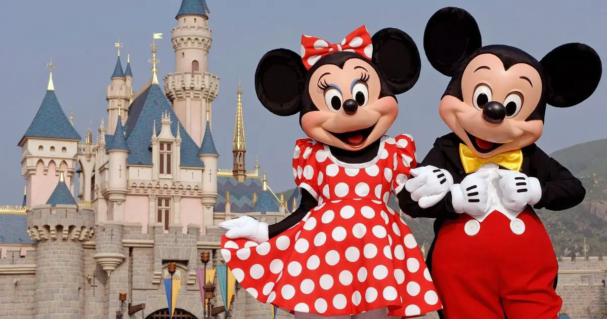 Minnie and Mickey Mouse at Disneyland outside of the castle
