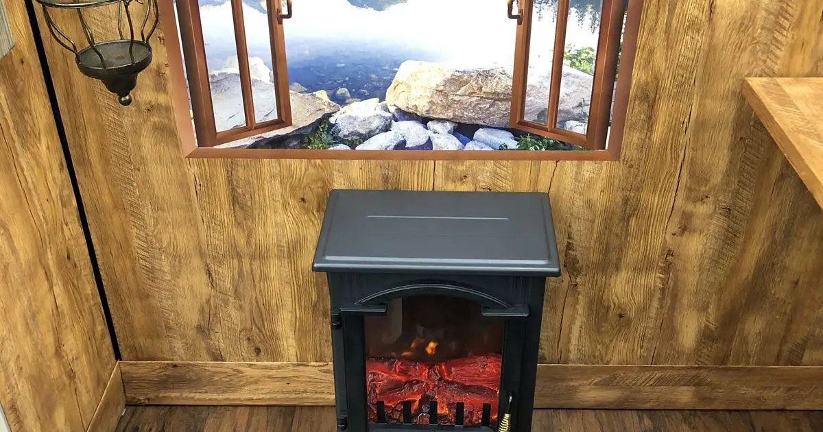 Office worker transforms workspace into mountain cabin complete with stove and moose head