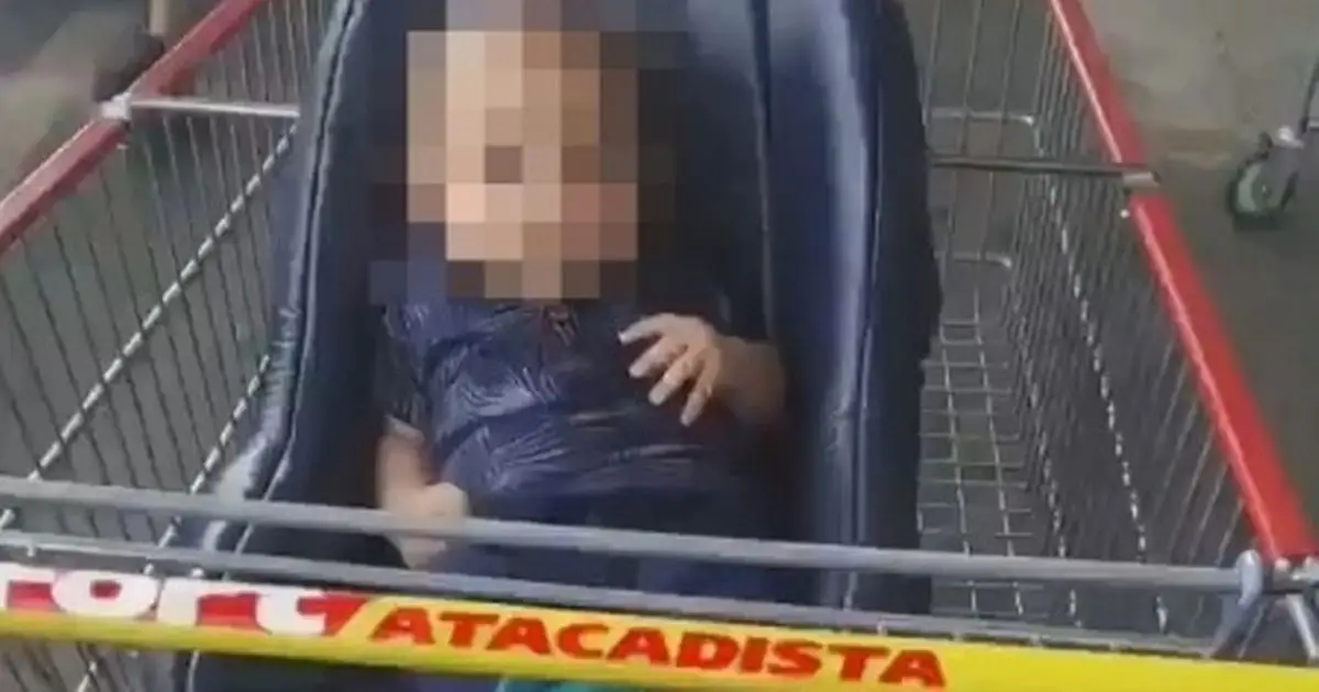 The baby in the trolley, his face blurred
