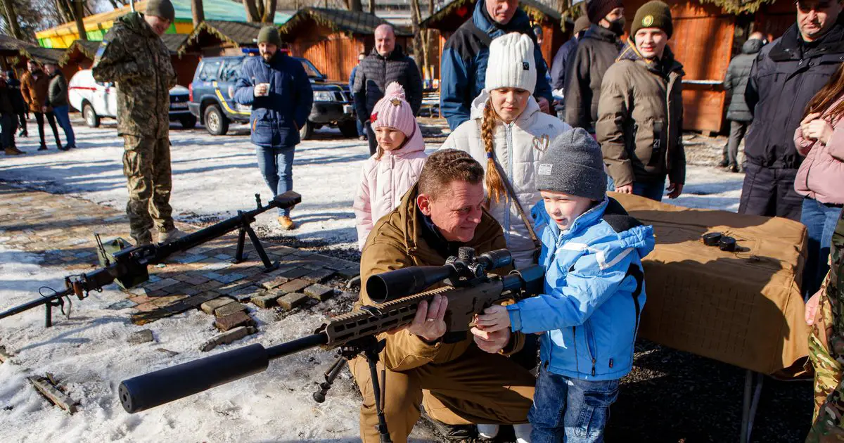 A boy handled a sniper rifle at the civil defence exercise in the city of Uzhhorod