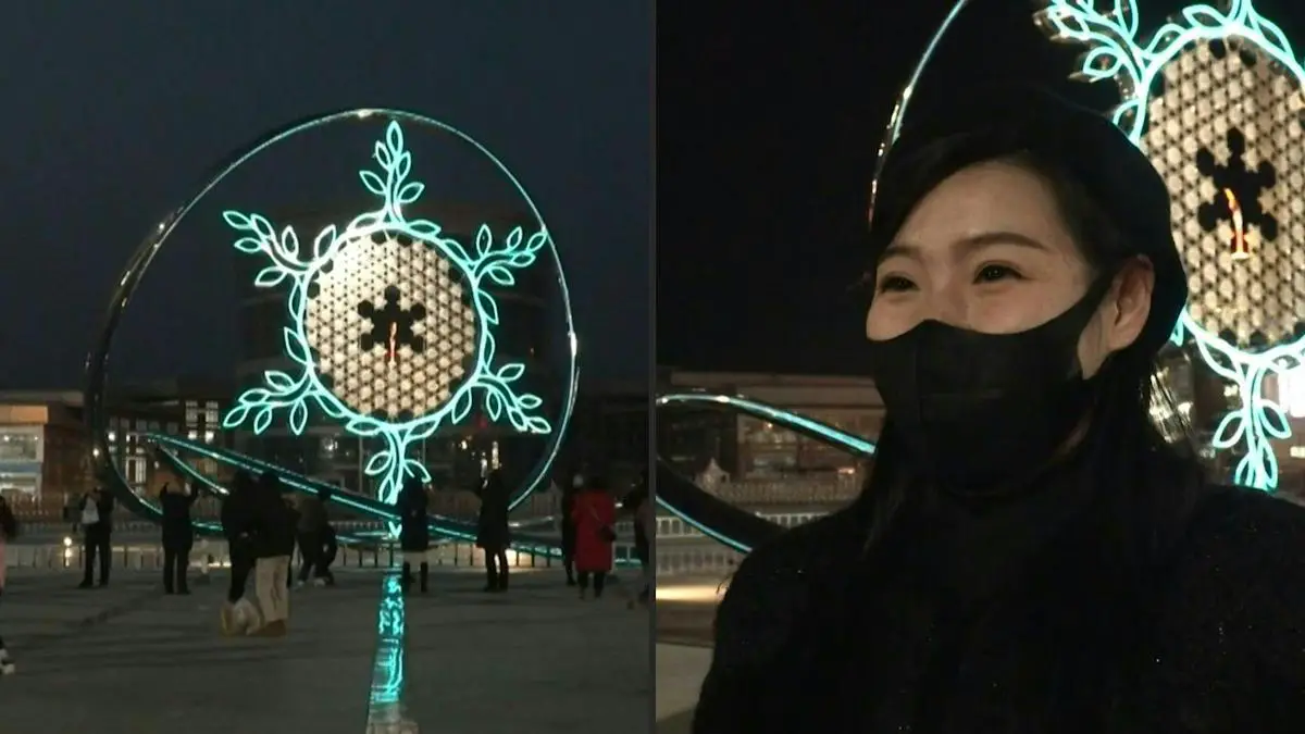 Fans gather at snowflake-shaped Olympic Cauldron