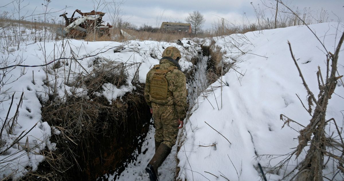A service member of the Ukrainian armed forces walks at combat positions near the line of separation from Russian-backed rebels