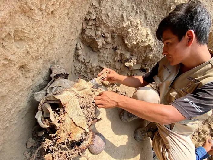 A Peruvian archeologist uncovers mummified remains in Cajamaquilla, Peru