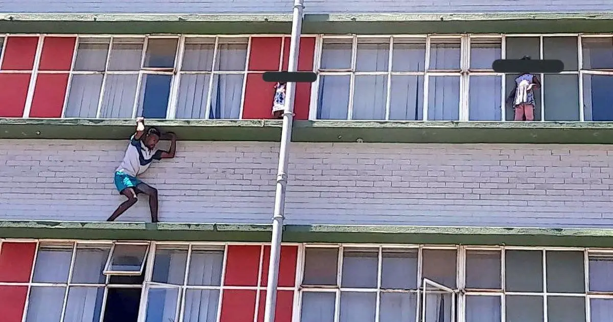 Two girls, 2 and 5, stuck on third-floor ledge after waking up and climbing out window