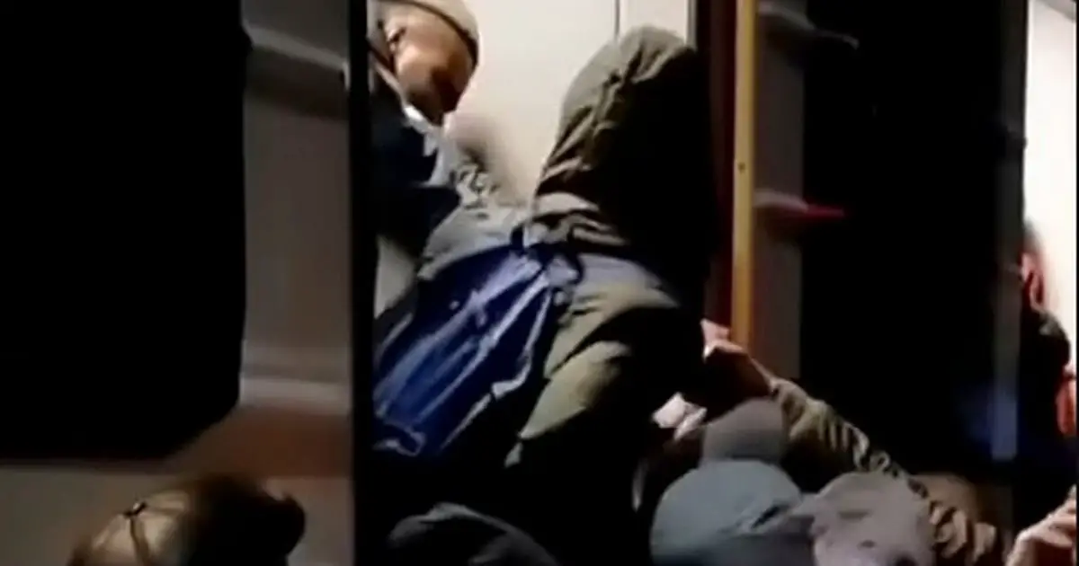 People try to clamber on board the train at Kyiv